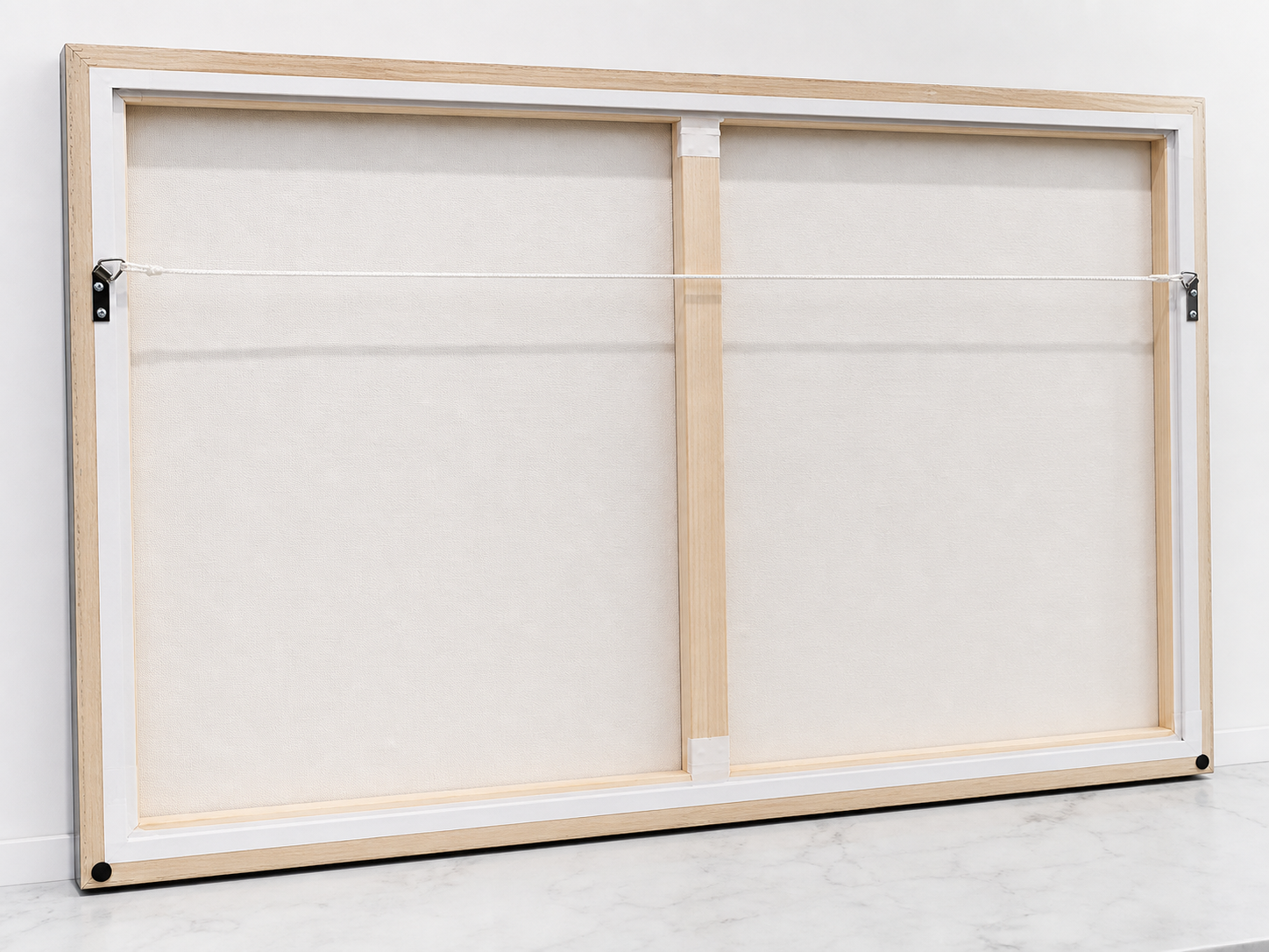 Back of a stretched canvas with timber stretcher bars and hanging cord