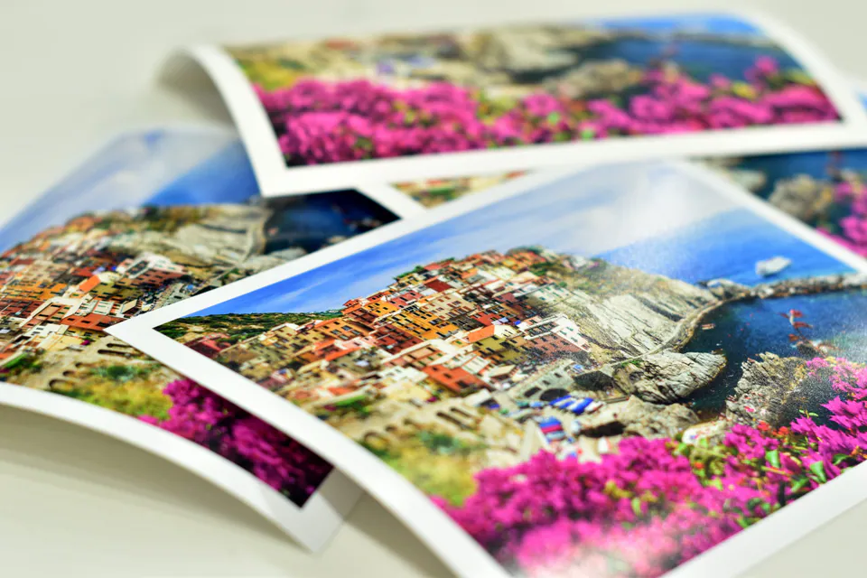 Colourful fine art photo prints stacked on premium paper